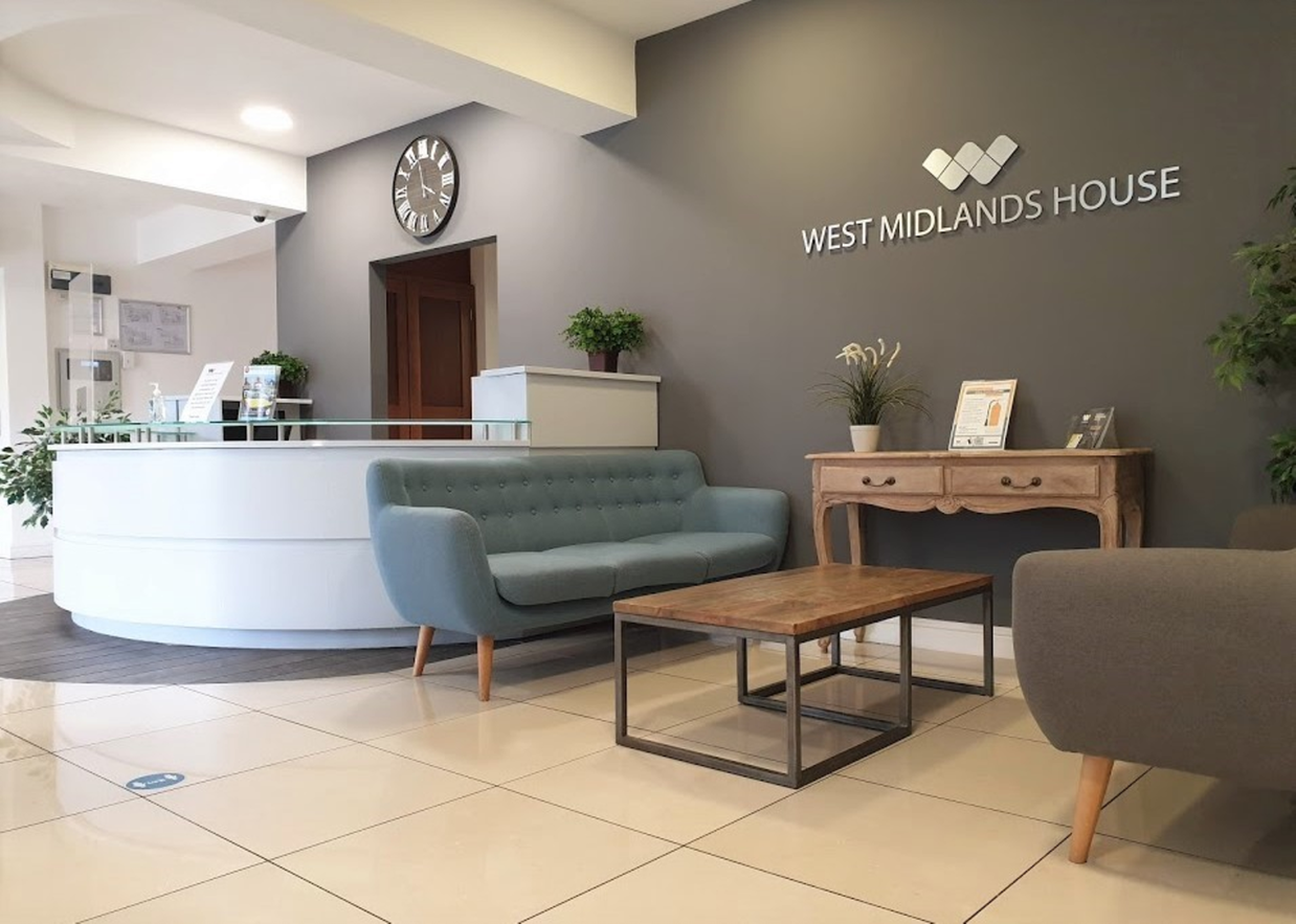 West Midlands House reception West Midlands House reception area - two sofas and a table, and reception desk